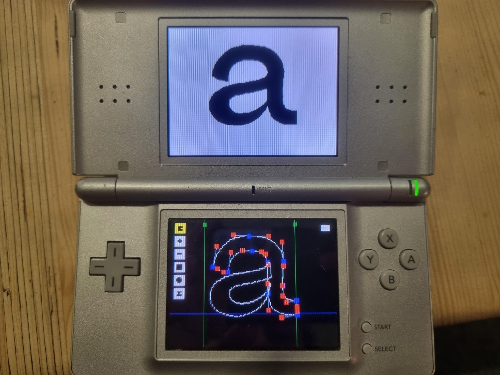 Nintendo DS running the font editor: top screen shows a rendered 'a', bottom screen shows the vector editing interface with control points.